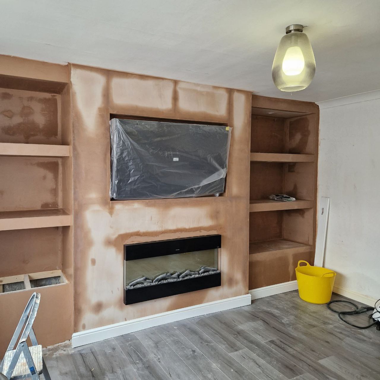 Built-in shelving and cable management on a media wall